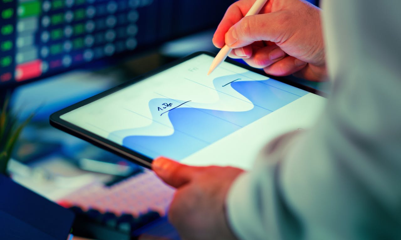 home-services-03 Professional analyzing data chart on a tablet with stylus in an office setting.